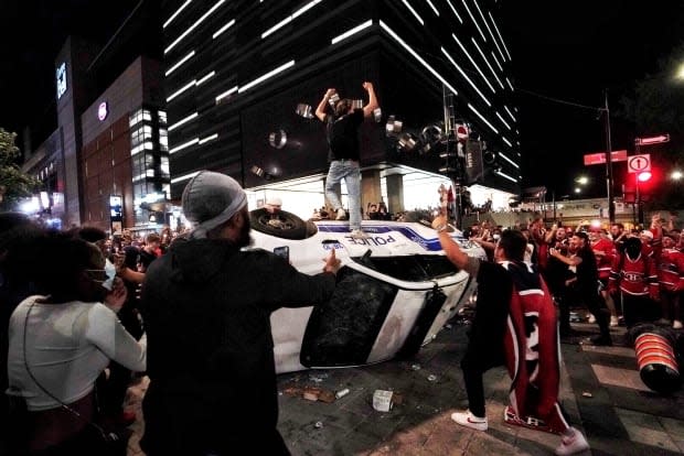 Some Habs fans in Montreal celebrated the Canadien's series-clinching win by flipping a police car. Police responded by shooting tear gas into the crowd.            (Ivanoh Demers/Radio-Canada - image credit)