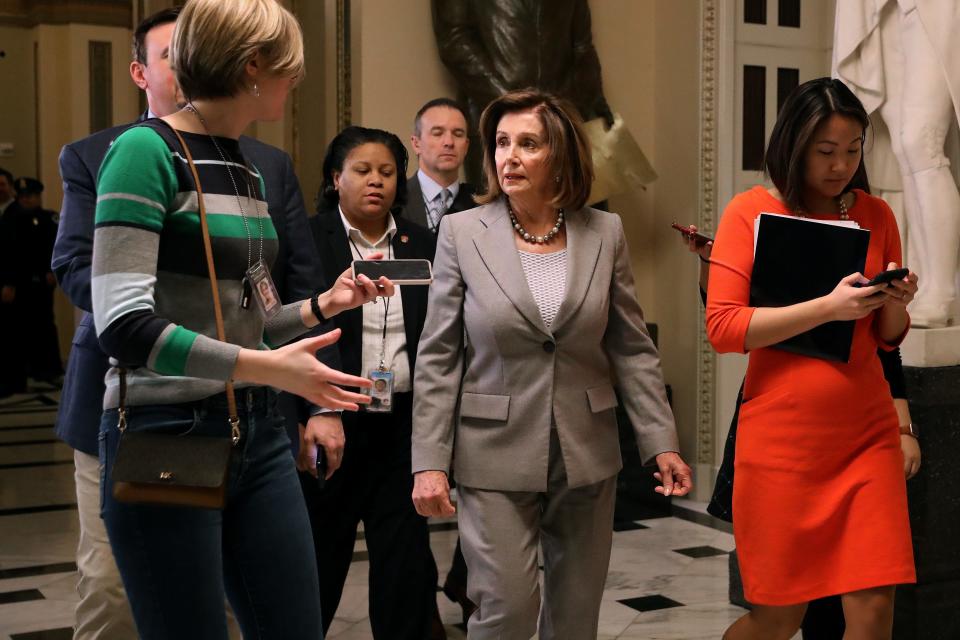 House Speaker Nancy Pelosi, D-Calif., answers questions from reporters as she leaves the House chamber on Jan. 10, 2020.