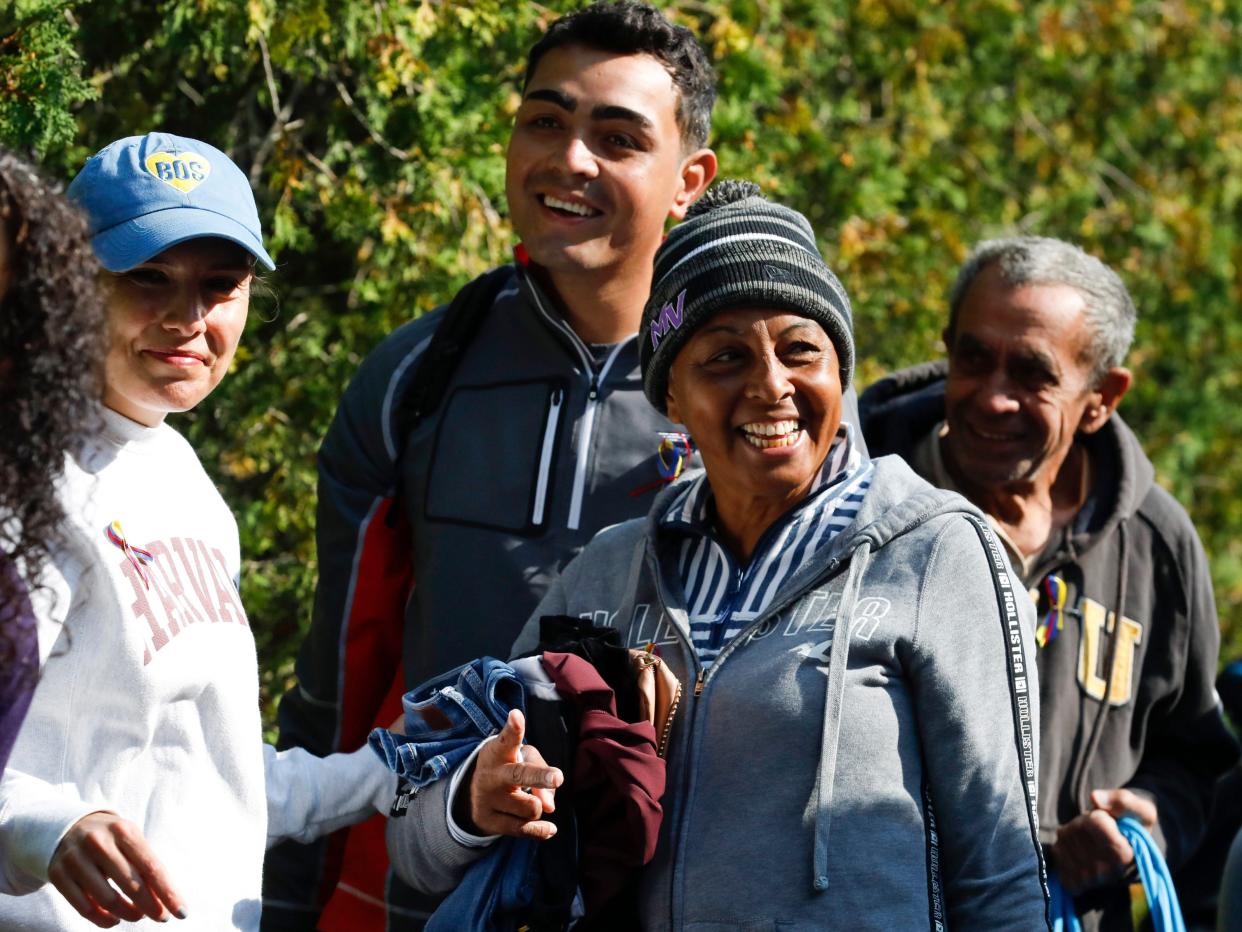 A Venezuelan migrant gathers outside of St. Andrew's Parish House on Martha's Vineyard to board a bus to the Vineyard Haven ferry terminal on September 16.