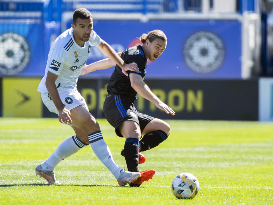 CF Montreal's Samuel Piette, right, challenges Chicago Fire FC's Luka Stojanovic during first half MLS soccer action in Montreal, Sunday, Sept. 19, 2021. (Graham Hughes/The Canadian Press via AP)