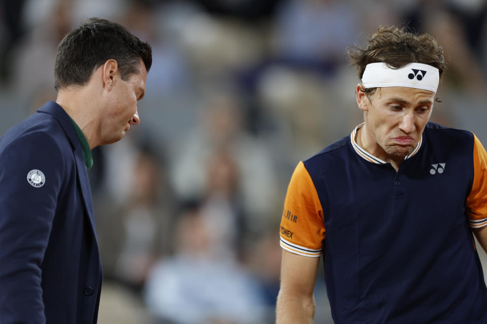 Norway's Casper Ruud questions a line call by chair umpire Nico Helwerth of Germany during the quarterfinal match against Denmark's Holger Rune of the French Open tennis tournament at the Roland Garros stadium in Paris, Wednesday, June 7, 2023. (AP Photo/Jean-Francois Badias)