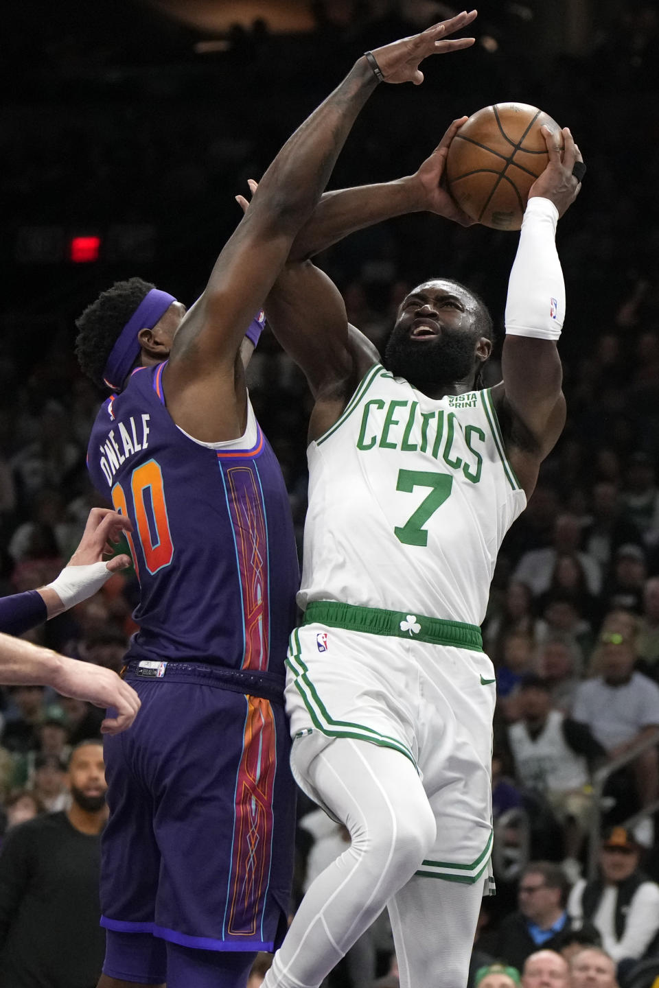 Boston Celtics guard Jaylen Brown (7) shoots over Phoenix Suns forward Royce O'Neale, left, during the first half of an NBA basketball game, Saturday, March 9, 2024, in Phoenix. (AP Photo/Rick Scuteri)