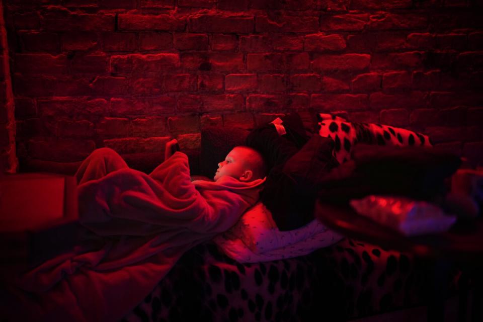 A boy in a public basement being used as a bomb shelter in Kyiv, Ukraine.