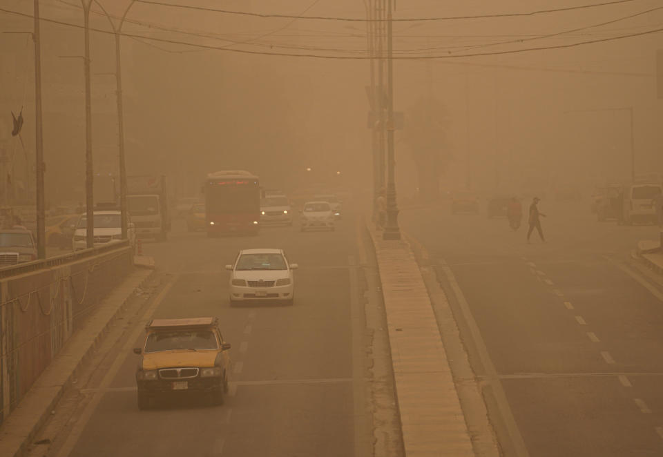 People drive vehicles on a street during a sandstorm in Baghdad, Iraq, Monday, May 23, 2022. (AP Photo/Hadi Mizban)