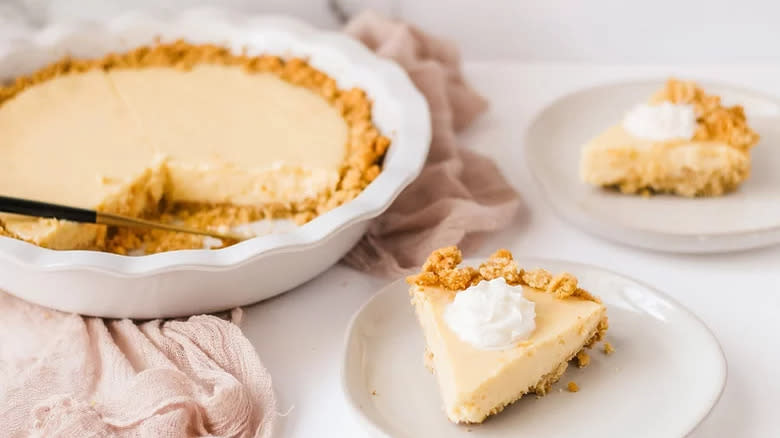 Lemon pie slices and pie with whipped cream