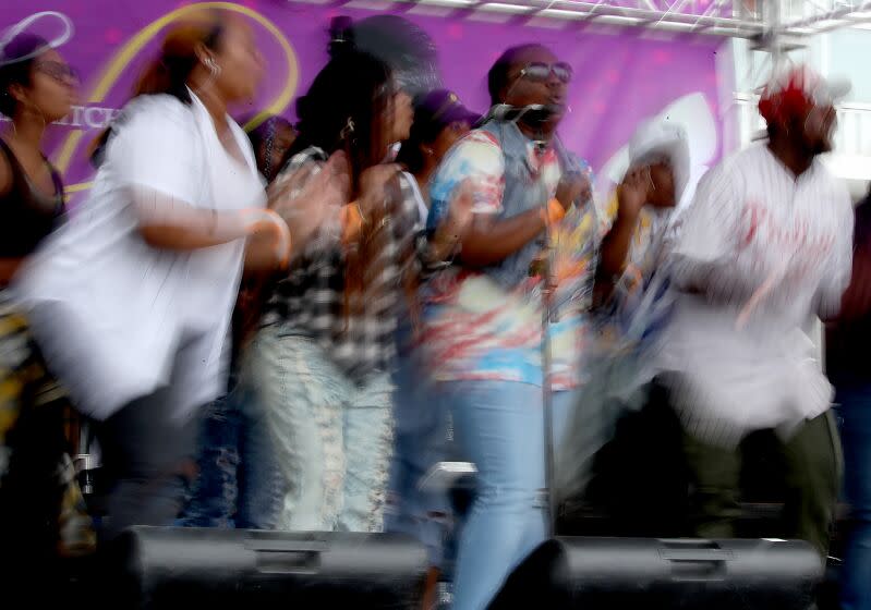 LOS ANGELES, CALIF. - OCT. 15, 2022. A gospel choir performs on a stage on Martin Luther King Jr. Boulevard during the Taste of Soul culture, music and food festival on Saturday, Oct. 15, 2022. The community event is a production of Bakewell Media. A newspaper publisher and longtime leader in the Black community, Danny Bakewell is a top L.A. power broker . (Luis Sinco / Los Angeles Times)