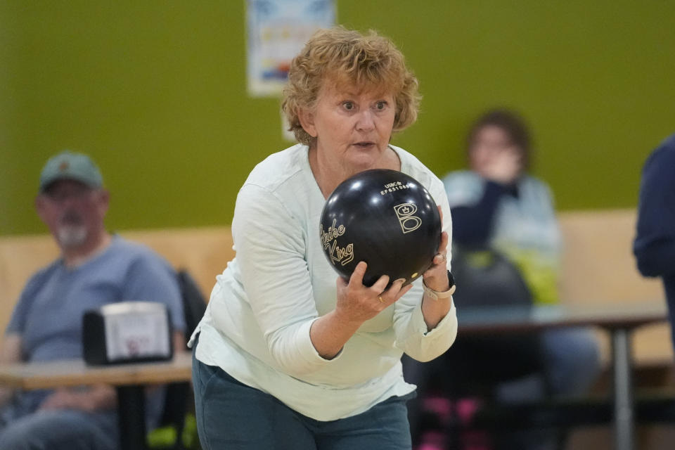 A bowler takes aim at Just In Time Recreation, Wednesday, May 1, 2024, in Lewiston, Maine. The bowling alley was scheduled to reopen Friday, May 3, seven months after the state's deadliest mass shooting. (AP Photo/Robert F. Bukaty)