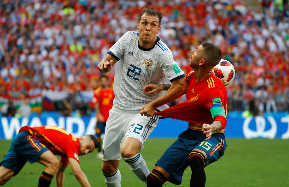 <p>Russia’s Artem Dzyuba in action with Sergio Ramos </p>