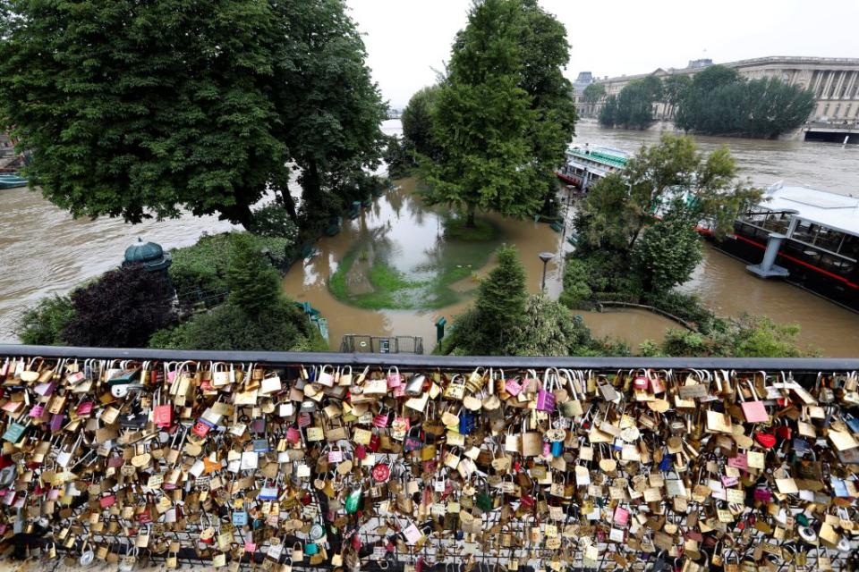 Padlocks clipped by lovers are seen in front of the Ile de La Cite. <span class="inline-image-credit">(Reuters/Charles Platiau)</span>