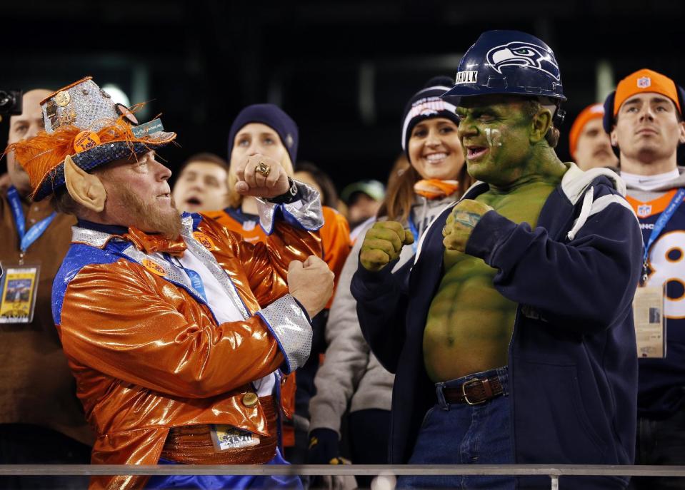 A Denver Broncos fan, left, and a Seattle Seahawks fan pose before the NFL Super Bowl XLVIII football game between the Seahawks and the Broncos, Sunday, Feb. 2, 2014, in East Rutherford, N.J. (AP Photo/Evan Vucci)