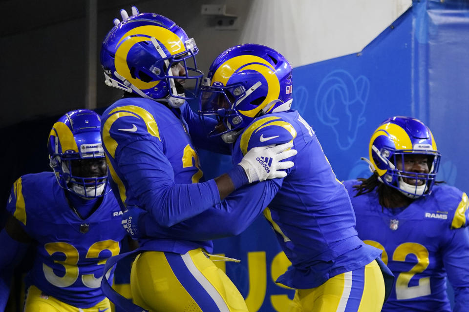 Los Angeles Rams defensive back David Long Jr., foreground left, is congratulated by cornerback Darious Williams after scoring on an interception return during the first half of an NFL wild-card playoff football game against the Arizona Cardinals in Inglewood, Calif., Monday, Jan. 17, 2022. (AP Photo/Jae C. Hong)