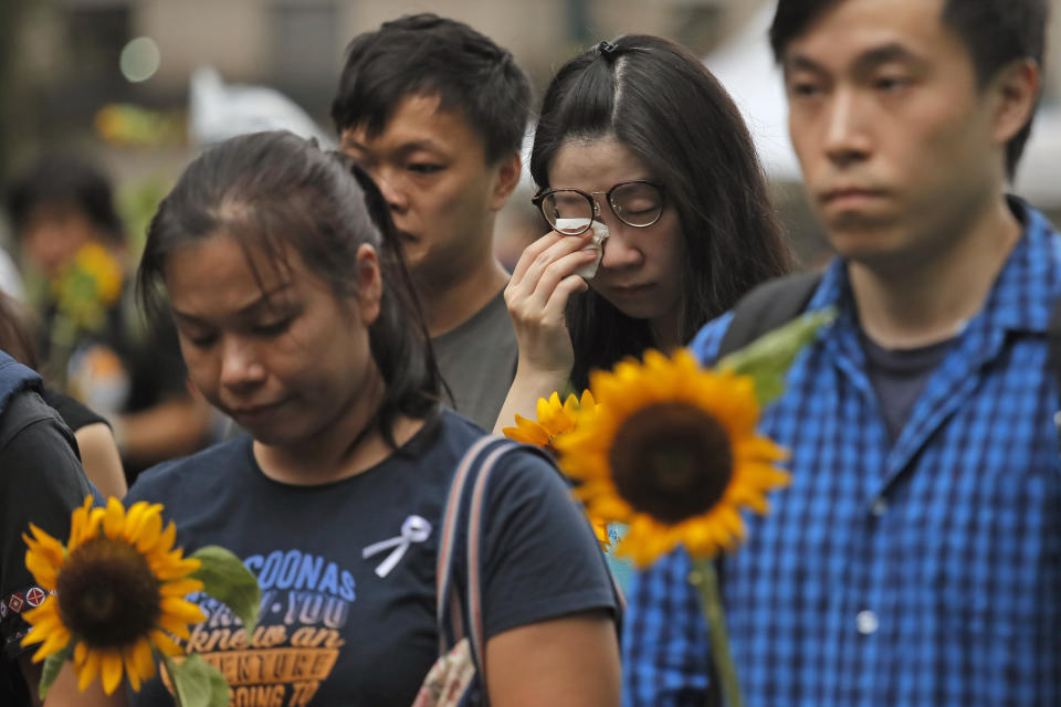 Attendees take part in a public memorial for Marco Leung, a 35-year-old man, who fell to his death weeks ago after hanging a protest banner against an extradition bill in Hong Kong, Thursday, July 11, 2019. The parents of Leung urged young people to stay alive to continue their struggle. (AP Photo/Kin Cheung)