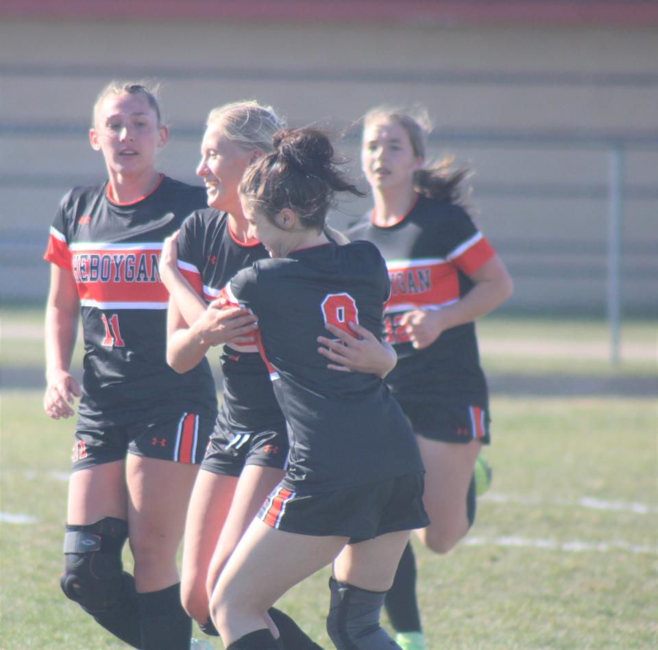 Cheboygan senior Taylor Bent gets congratulated by teammates after scoring a goal during the first half against Roscommon on Monday.