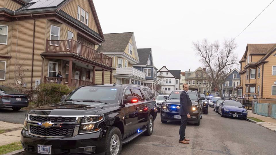 a person standing next to an suv