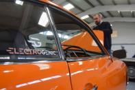 Steve Drummond, co-founder of Electrogenic opens up the hood of a converted Volkswagen Karmann Ghia, in Kidlington