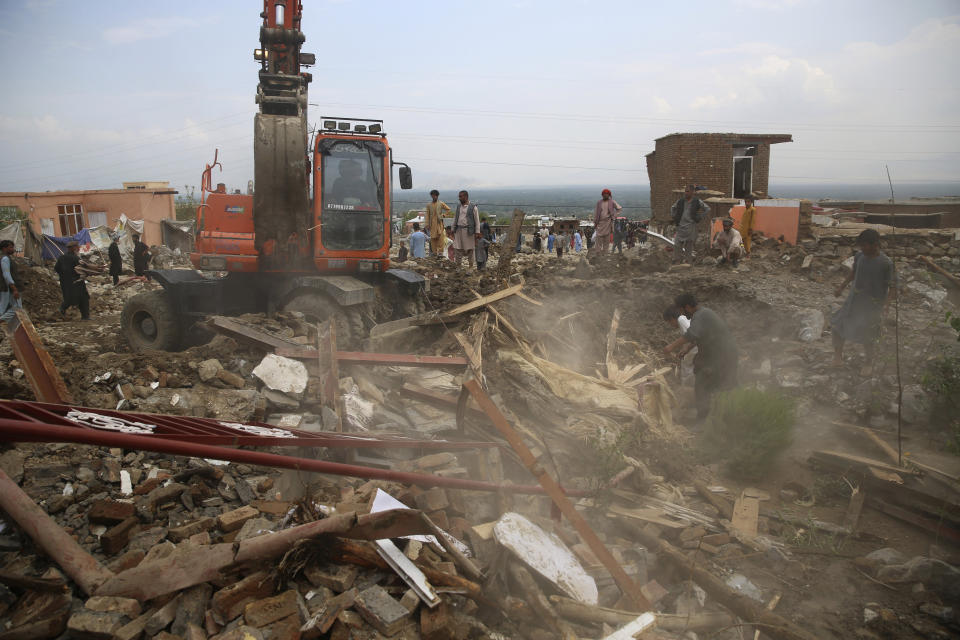 Rescuers search for bodies after a mudslide during heavy flooding in Parwan province, north of Kabul, Afghanistan, Wednesday, Aug. 26, 2020. Flooding in northern Afghanistan killed and injured dozens of people officials said Wednesday. (AP Photo/Rahmat Gul)