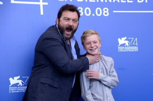 "Custody" stars Denis Menochet (L) and Thomas Gioria joke around at the 74th Venice Film Festival in September 2017