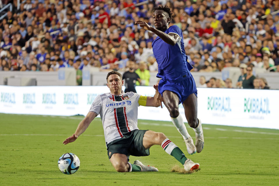 Chelsea's Nicolas Jackson, right, moves the ball past Wrexham's Ben Tozer during the first half of a club friendly soccer match Wednesday, July 19, 2023, in Chapel Hill, N.C. (AP Photo/Karl B DeBlaker)