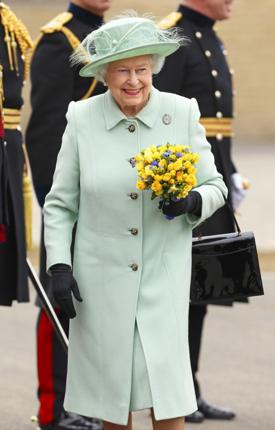 <p>In 2013 The Queen re-wore this pastel coloured coat and cute fluffy hat, but this time paired it with black gloves. [Photo: Getty] </p>