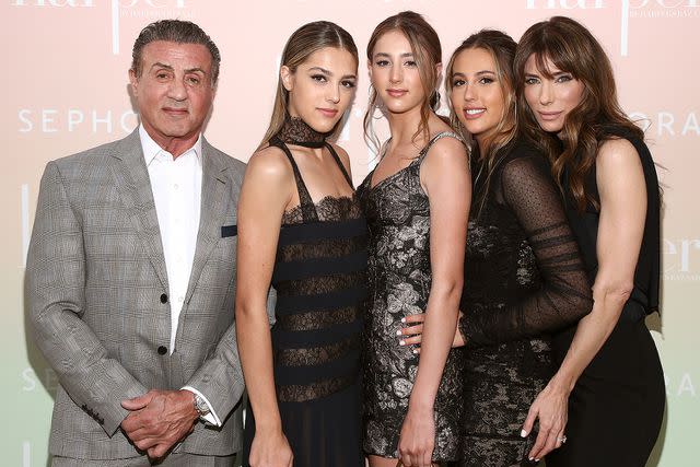 <p>John Salangsang/WWD/Penske Media via Getty</p> Sylvester Stallone with daughters (from left) Sistine, Scarlet, and Sophia and wife Jennifer Flavin