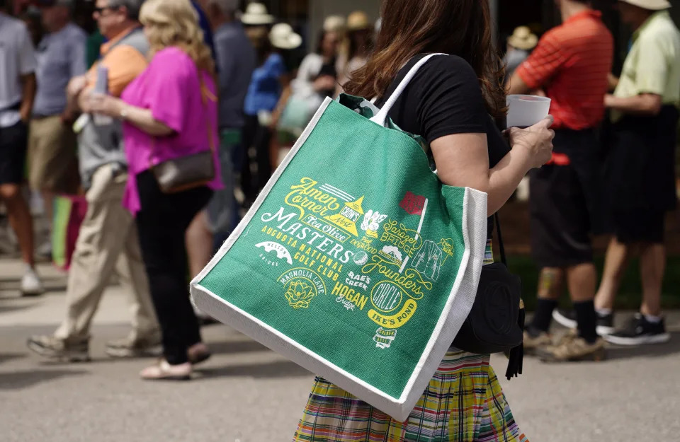 Apr 2, 2022; Augusta, Georgia; A patron carries her purchases at the Augusta National Women's Amateur golf tournament. (Katie Goodale-Augusta Chronicle/USA TODAY Network)