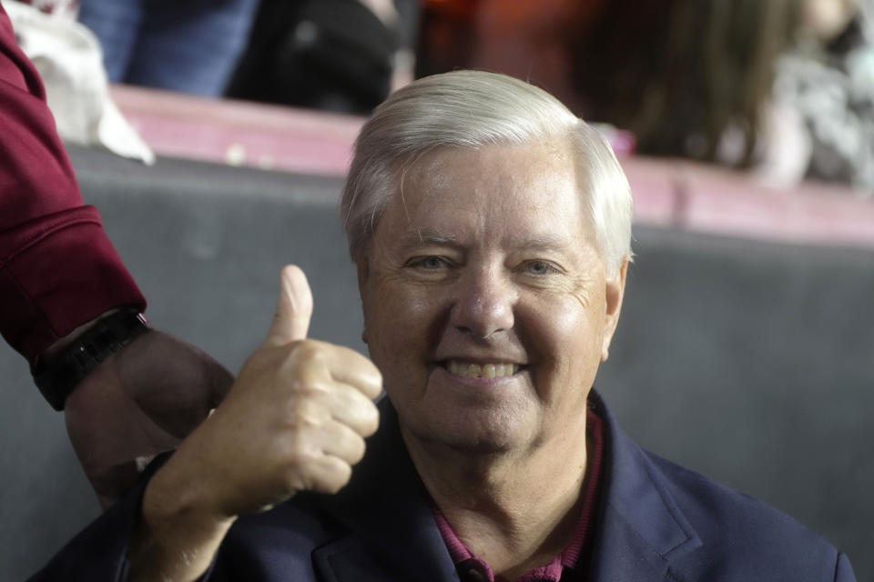 Sen. Lindsey Graham, R-S.C., gives a thumbs up on the sidelines of the annual football match between the University of South Carolina and Clemson University on Saturday, Nov. 25, 2023, in Columbia, S.C. (AP Photo/Meg Kinnard)