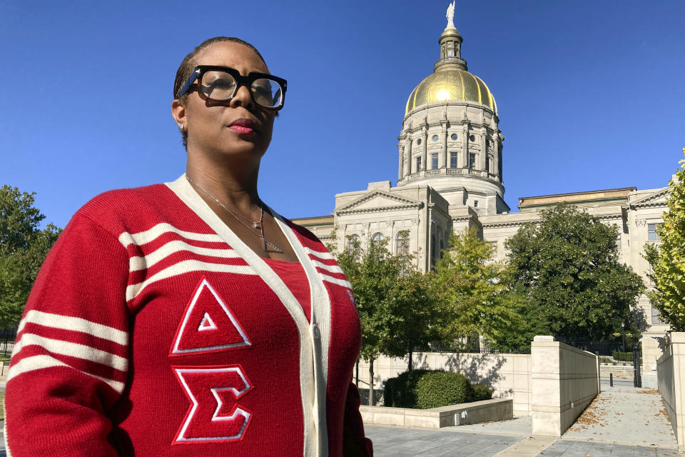 Rhonda Briggins, former co-chair of the Delta Sigma Theta National Social Action Commission and member of the sorority's Decatur alumnae chapter, poses for a photo at the state Capitol in Atlanta, Oct. 14, 2022, in Atlanta. Briggins spent the 2020 election at an Atlanta polling place handing out water and snacks to encourage voters to stay in an hours-long line to cast their ballot, something her historic Black sorority has done for decades in Georgia. (AP Photo/Sudhin Thanawala)