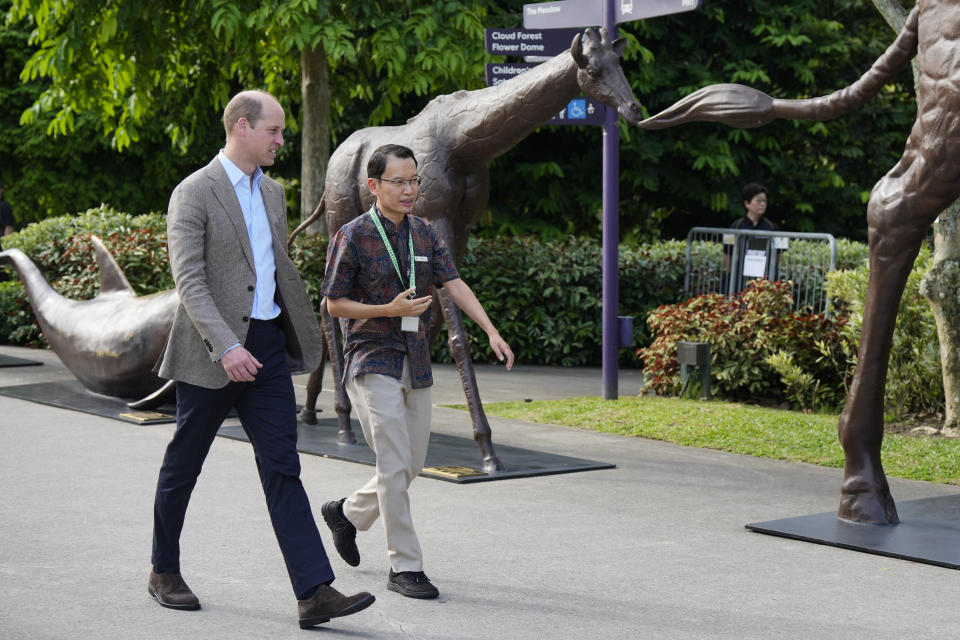 Britain's Prince William, left, walks with Felix Loh, CEO of The Gardens by the Bay, as the prince arrived to meet with Earthshot finalists at the city-state's famed park in Singapore, Tuesday, Nov. 7, 2023. William is in Singapore for the annual The Earthshot Prize awards ceremony, the first to be held in Asia. William and his charity launched the global competition in 2020 to promote innovative solutions and technologies to combat global warming and protect the planet. (AP Photo/Vincent Thian)