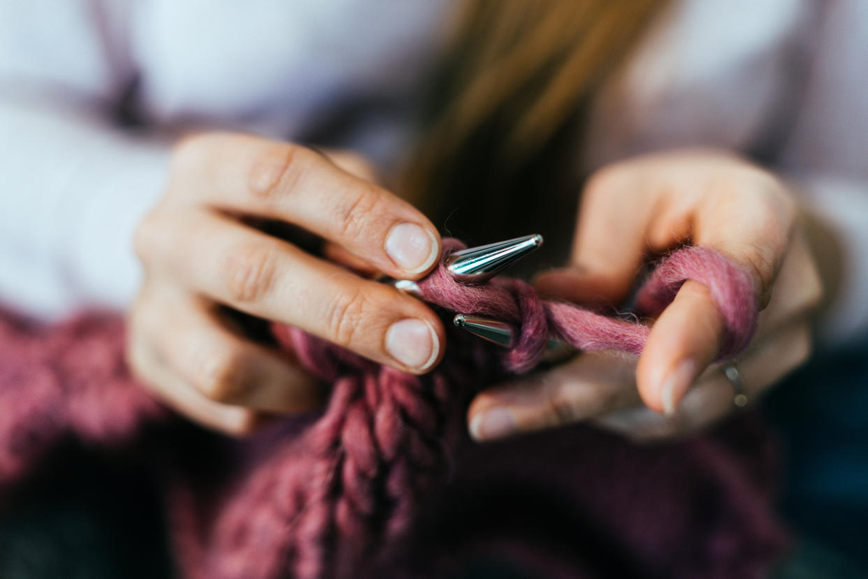 Woman knitting at home, close-up. (Getty Images)