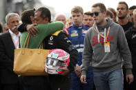 The mother, left, and brother, second right, of Anthoine Hubert during a moment of silence for Formula 2 driver Anthoine Hubert at the Belgian Formula One Grand Prix circuit in Spa-Francorchamps, Belgium, Sunday, Sept. 1, 2019. The 22-year-old Hubert died following an estimated 160 mph (257 kph) collision on Lap 2 at the high-speed Spa-Francorchamps track, which earlier Saturday saw qualifying for Sunday's Formula One race. (AP Photo/Francisco Seco)