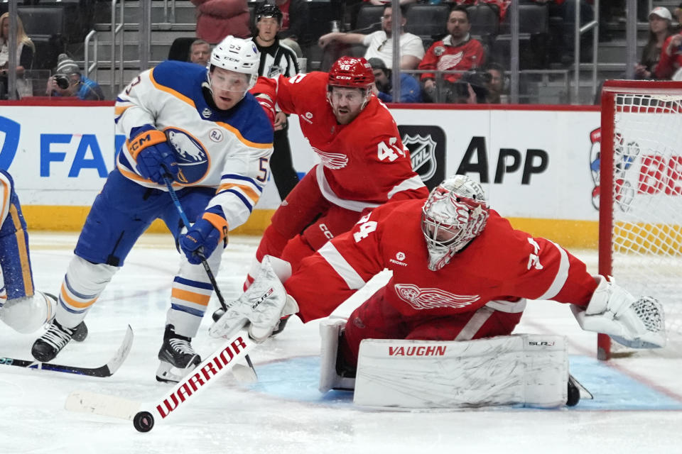 Detroit Red Wings goaltender Alex Lyon (34) stops a Buffalo Sabres left wing Jeff Skinner (53) shot as Jeff Petry (46) defends in the second third of an NHL hockey game Sunday, April 7, 2024, in Detroit. (AP Photo/Paul Sancya)