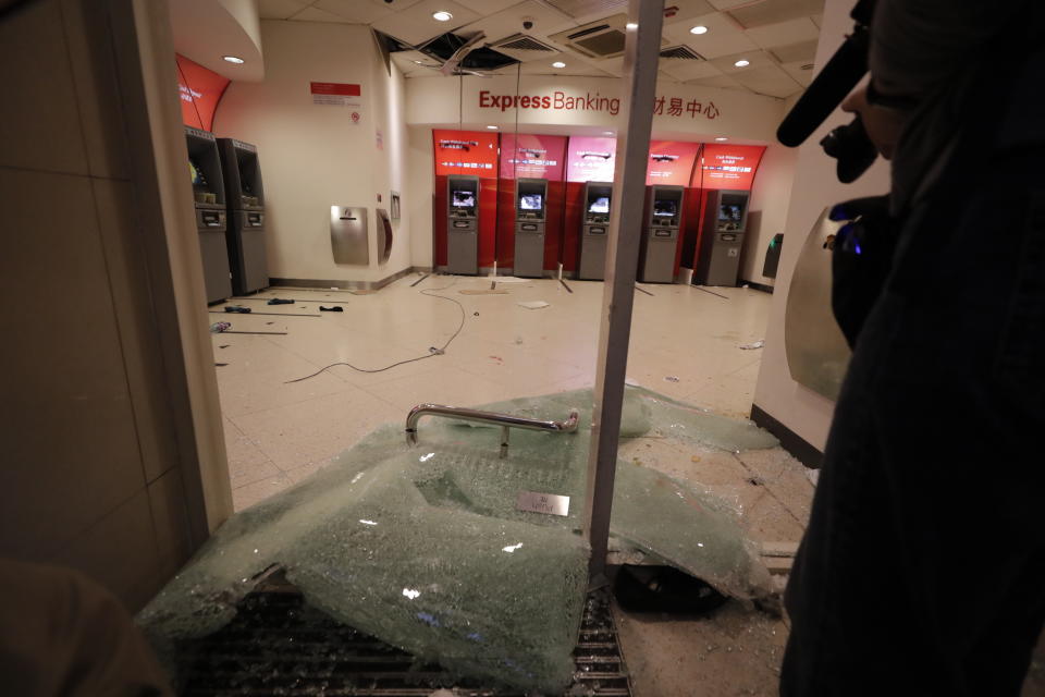 Protestors vandalize a HSBC branch in Hong Kong, Wednesday, Jan. 1, 2020. A huge crowd gathered in Hong Kong Wednesday for an annual New Year’s Day protest march as the monthslong pro-democracy movement extends into 2020. (AP Photo/Lee Jin-man)