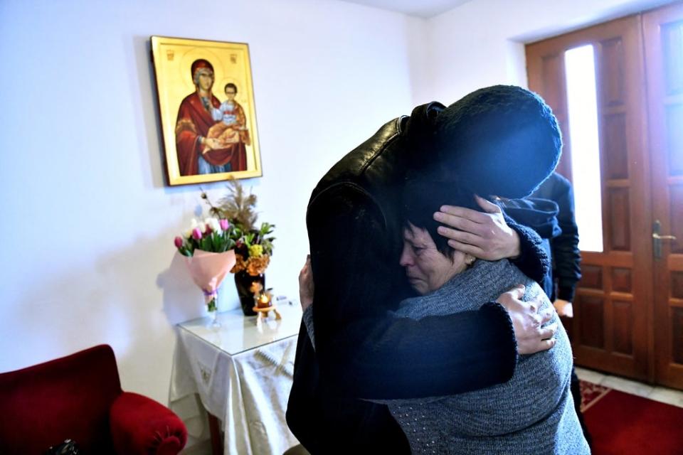 Father Gherasim Soca comforts Svetlana as she cries (Reuters)