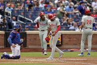 Philadelphia Phillies' Johan Rojas scores a run after Alec Bohm (28) was hit by a pitch with the bases loaded as New York Mets catcher Omar Narváez looks away during the third inning of a baseball game Tuesday, May 14, 2024, in New York. (AP Photo/Adam Hunger)