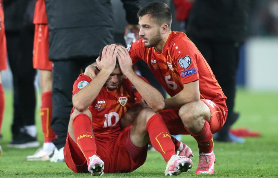 Goran Pandev, overcome by emotion, is comforted by a teammate Boban Nikolov after Pandev’s goal against Georgia took North Macedonia to Euro 2020