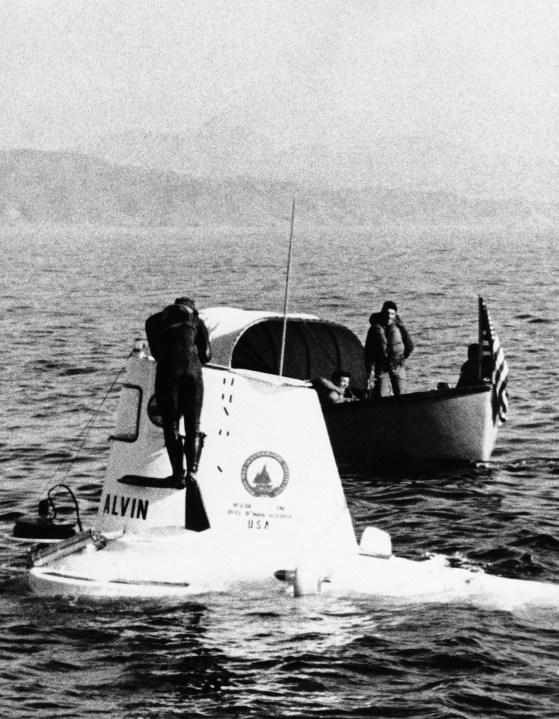 The two-man Midget submarine Alvin, which made pictures indicating that the H-bomb missing off Palomares Beach, Spain on March 18, 1966, had been located, is near the Spanish Coast. A frogman checks with crewmen inside the tiny craft as a U.S. Navy launch stands by. The sub what official sources said was undoubtedly the bomb five miles off the southern coast of Spain and 2,500 feet below the surface. (AP Photo)