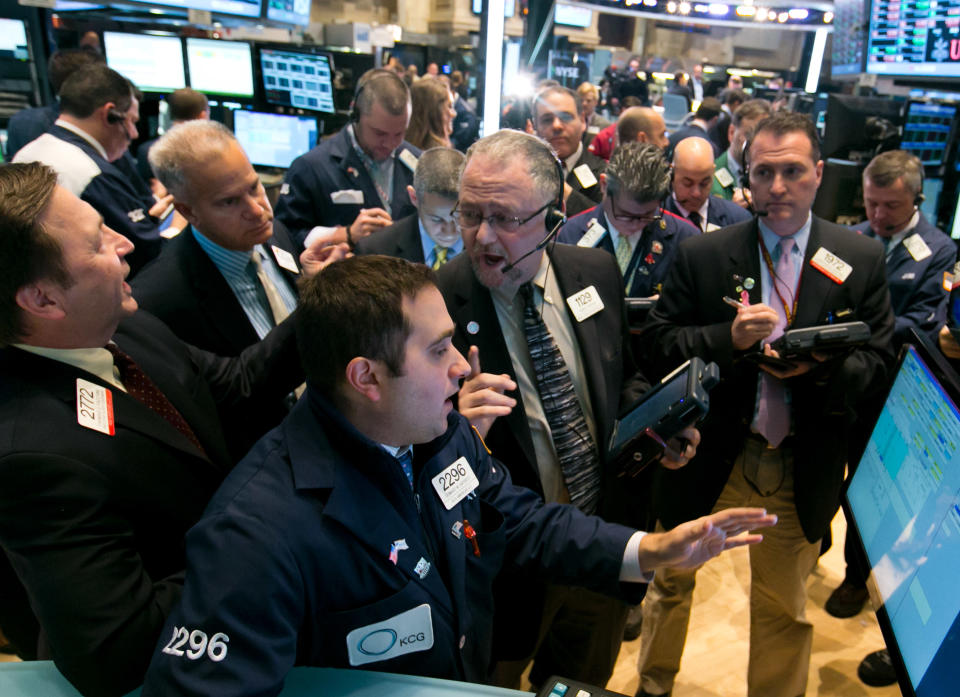 Trader Robert Moran, center, works with specialist Gennaro Saporito, foreground, during the IPO of Continental Building Products, on the floor of the New York Stock Exchange Wednesday, Feb. 5, 2014. The U.S. stock market is edging lower in early trading after a modest recovery the day before. (AP Photo/Richard Drew)