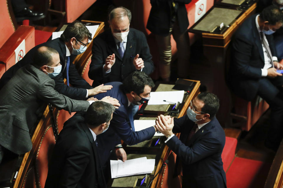 Leader of Italy's far-right League party Matteo Salvini, right, ahead of a confidence vote at the Senate in Rome, Tuesday, Jan. 19, 2021. Italian Premier Giuseppe Conte fights for his political life with an address aimed at shoring up support for his government, which has come under fire from former Premier Matteo Renzi's tiny but key Italia Viva (Italy Alive) party over plans to relaunch the pandemic-ravaged economy. (Yara Nardi/pool photo via AP)