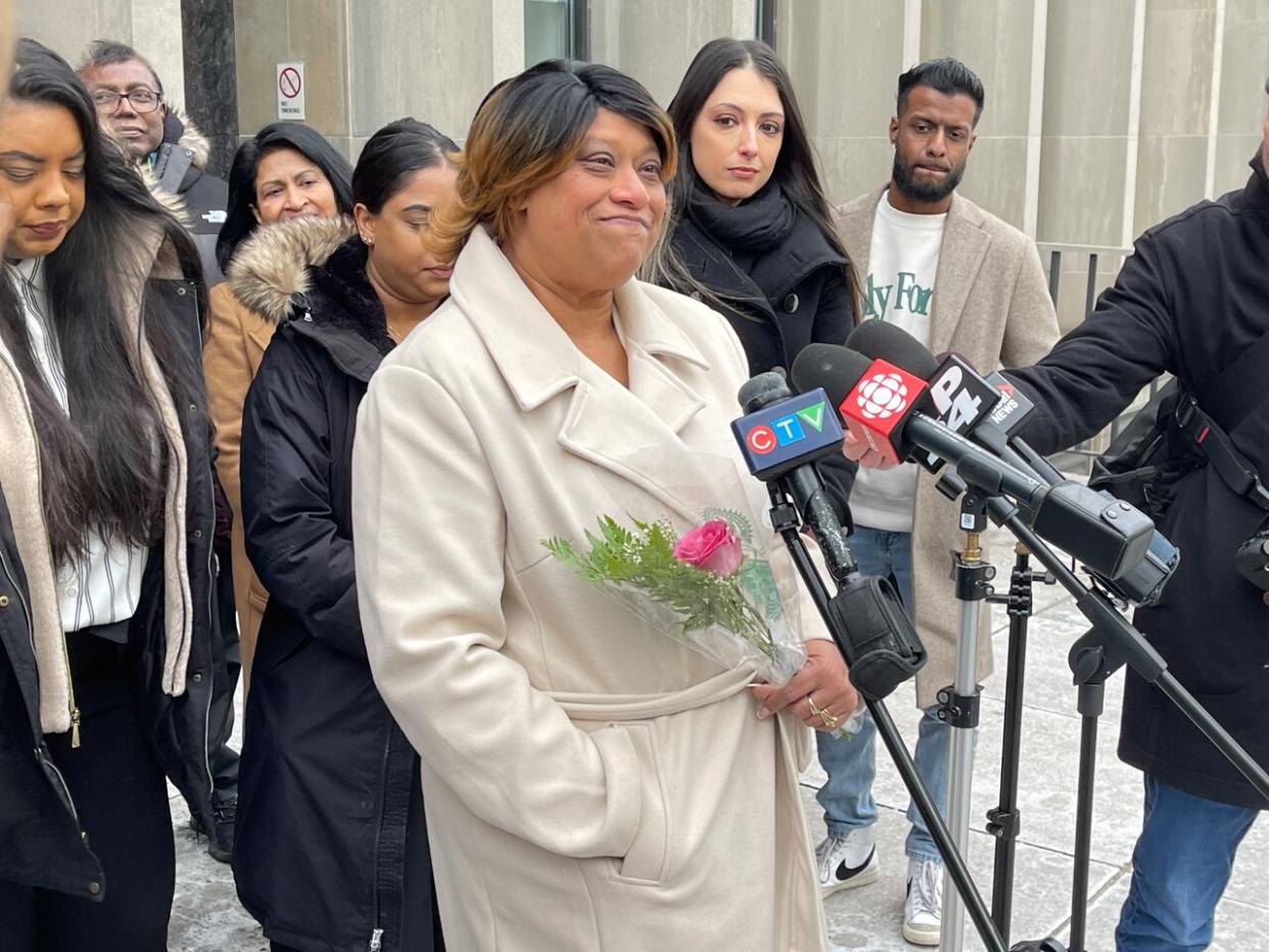 Cindy Ali, seen here flanked by supporters outside court in downtown Toronto, was previously convicted in the death of her 16-year-old daughter Cynara, who died in 2011. Ali was acquitted during a retrial on Friday morning. (Thomas Daigle/CBC - image credit)