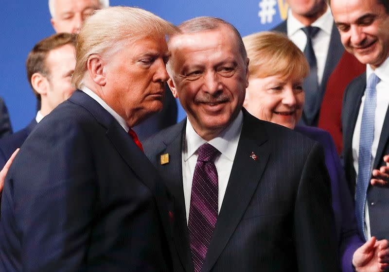 FILE PHOTO: U.S. President Donald Trump and Turkey's President Recep Tayyip Erdogan leave the stage after family photo during the annual NATO heads of government summit at the Grove Hotel in Watford