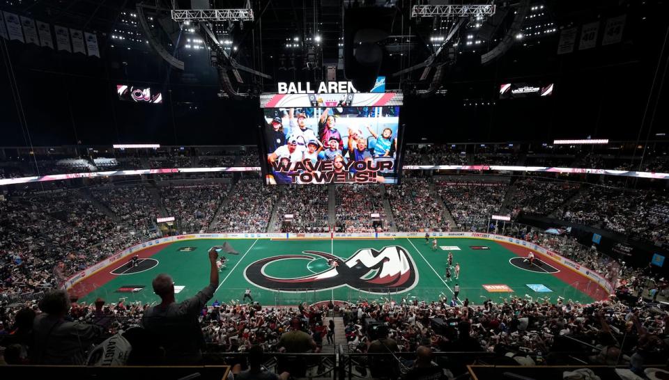 Fans wave towels as the Buffalo Bandits take on the Colorado Mammoth during the first half of Game 2 of the National Lacrosse League Finals in June 2022 in Denver.