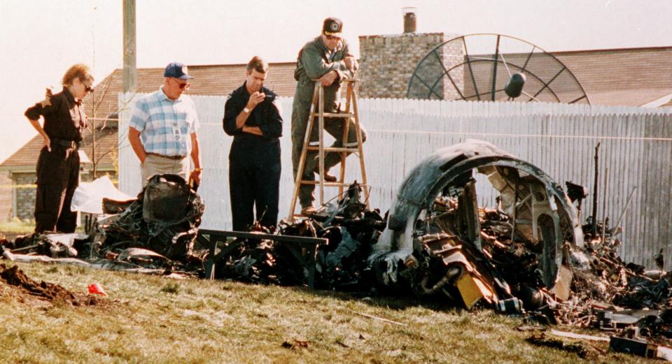 Investigators (from left) Polly Hix, John Johnson, Kevin Poe and Lew Owens check the crash site where four of Indianapolis' most influential civic leaders died in a mid-air collision on Sept. 11, 1992.
