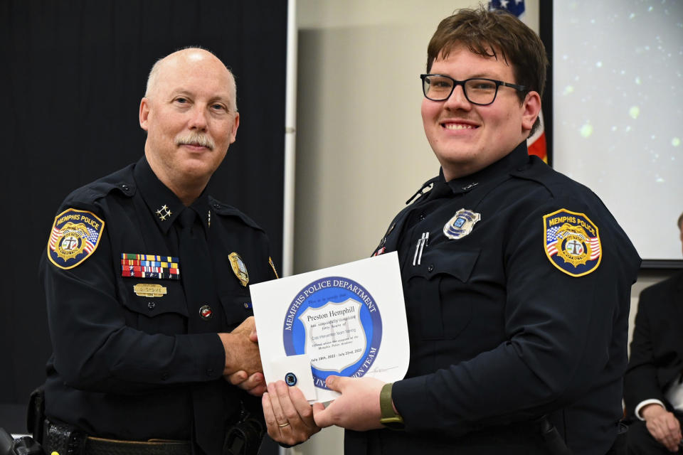 In this photo obtained from the Memphis Police Department's Facebook page, Preston Hemphill receives a certificate from Memphis Assistant Chief of Police Don Crowe after completing the training to join the department's Crisis Intervention Team on July 21, 2022. Police officials said Monday, Jan. 30, 2023, that Hemphill and another officer were relieved of duty in connection with the death of Tyre Nichols, widening the circle of punishment for the shocking display of police brutality after video showed many more people failed to help him beyond the five officers accused of beating him to death. (Memphis Police Department via AP)