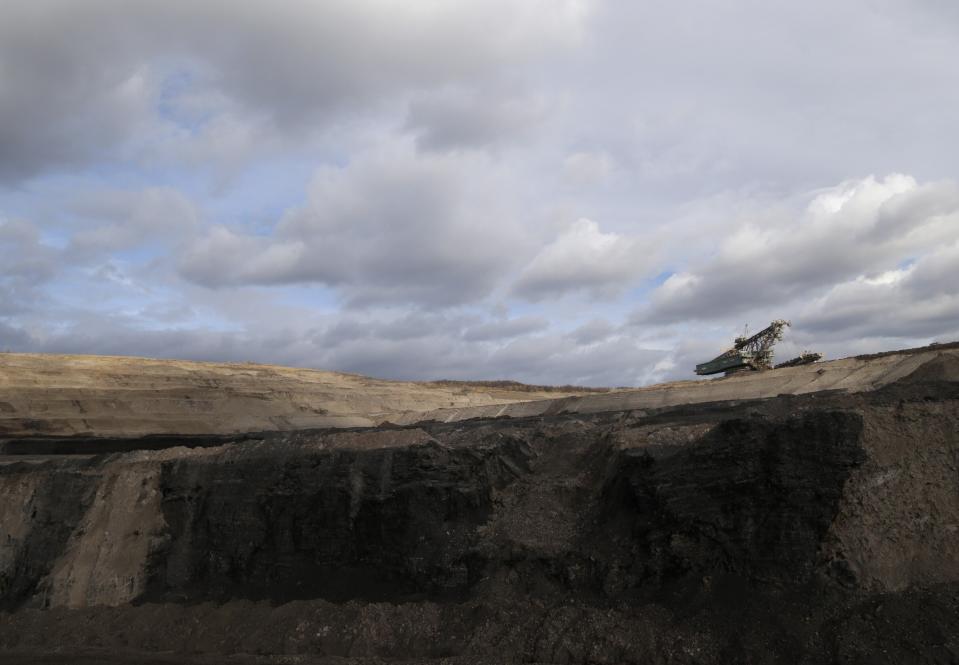 File - In this file photo taken on Thursday, Nov. 12, 2015 near the town of Most, Czech Republic, a huge excavator stands inside a giant open pit lignite mine. On Friday Dec. 4, 2020, a Czech government advisory committee has agreed on a proposal for the country to phase out coal as an energy source by 2038, a plan that environmental groups say isn't ambitious enough. (AP Photo/Petr David Josek/File)