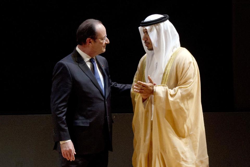 French President Francois Hollande, left, talks with Sheikh Sultan Bin Tahnoon Al Nathyan, Abu Dhabi authority president for tourism and culture, as they visit the exhibition 'Birth of a Museum', at the Louvre museum, Tuesday April 29, 2014, in Paris. The 'Birth of a Museum' exposition presents paintings, sculptures, and other artworks that the famous French Louvre museum will send to the new Louvre museum branch in Abu Dhabi, in the United Arab Emirates, and which is expected to open in 2015. (AP Photo/Alain Jocard, Pool)