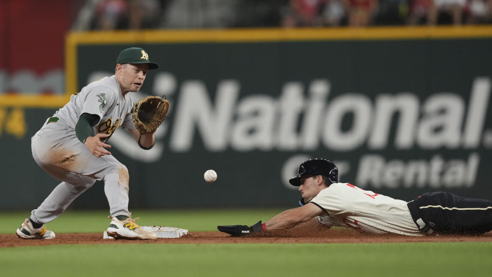 Texas Rangers' Evan Carter, right, slides in to steal second base against Oakland Athletics shortstop Nick Allen, left, during the second inning of a baseball game in Arlington, Texas, Friday, Sept. 8, 2023. (AP Photo/LM Otero)