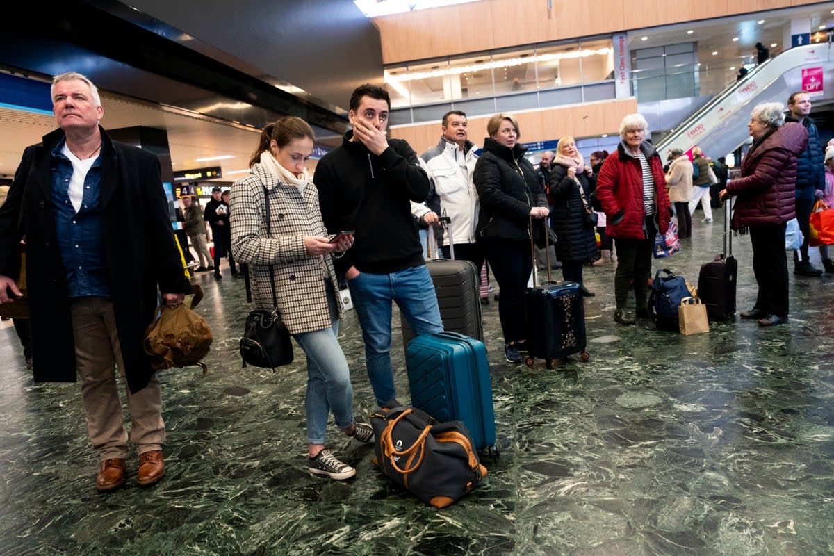 Passengers at Euston station in London facing delays to trains as the Uk is hit by Storm Isha (Jordan Pettitt/PA)