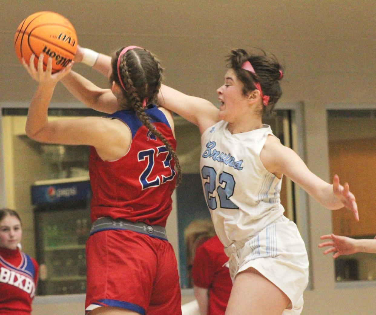 Bartlesville High senior guard Kate Gronigan, right, goes all out to defend a shot during Tuesday's home battle against Bixby High.