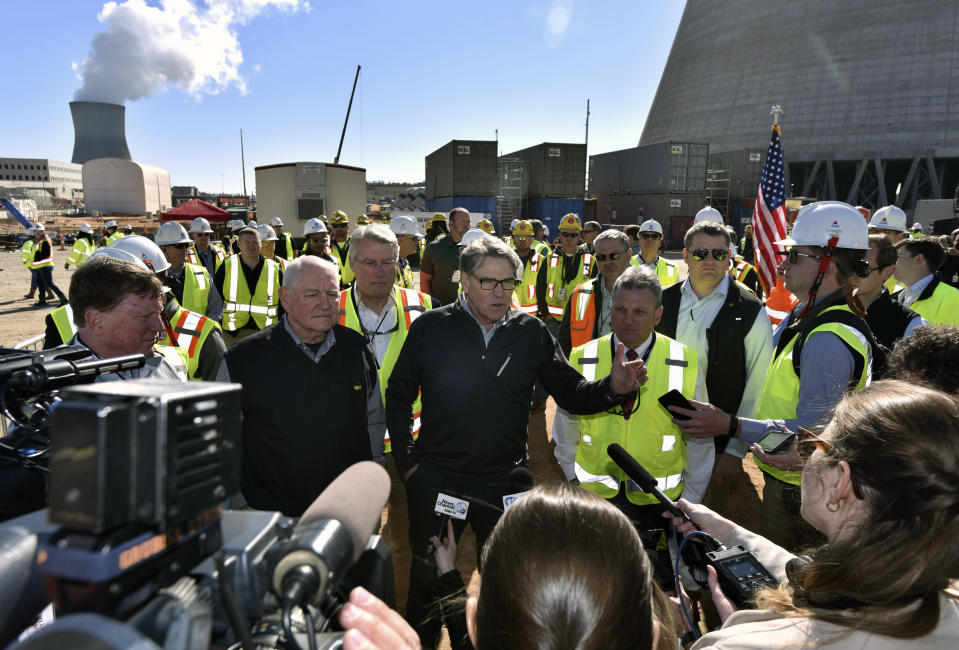 FILE - U.S. Secretary of Energy Rick Perry speaks to reporters after announcing more federal loan guarantees at the construction site of Vogtle Units 3 and 4 on March 22, 2019, in Waynesboro, Ga. The federal government consistently supported Vogtle’s construction across the administrations of George W. Bush, Barack Obama and Donald Trump. (Hyosub Shin/Atlanta Journal-Constitution via AP, File)