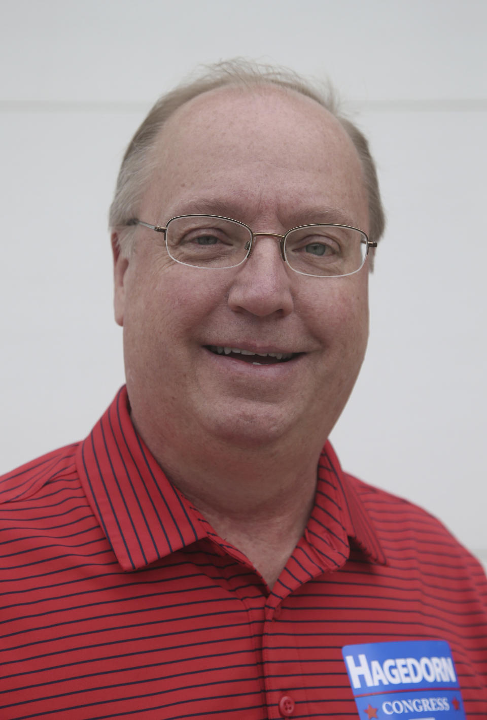 In this June 10, 2018 photo, Minnesota 1st District congressional candidate Jim Hagedorn poses before a parade in Waterville, Minn. Waterville's 54th annual Bullhead Days parade included Republican Hagedorn and Democrat Dan Feehan, candidates who came to shake as many hands as they could in the open seat race which promises to be one of the most closely watched races in the country. (AP Photo/Jim Mone)